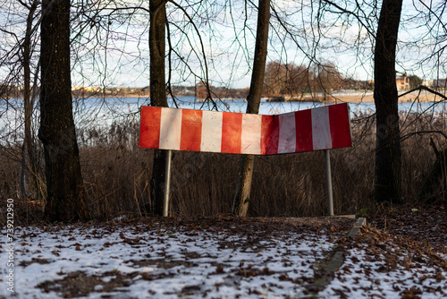 Fototapeta Naklejka Na Ścianę i Meble -  Old broken road sign in the winter forest