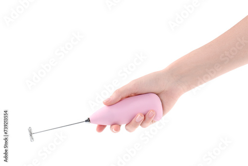 Woman holding pink milk frother wand on white background, closeup photo