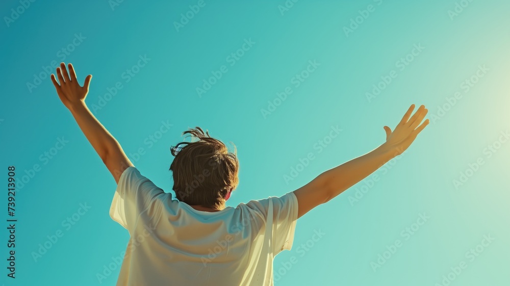 Person with arms raised towards the sunny blue sky