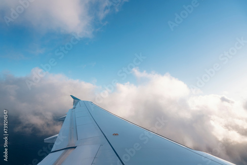 Wing of the plane on blue sky background Space for text. Banner concept
