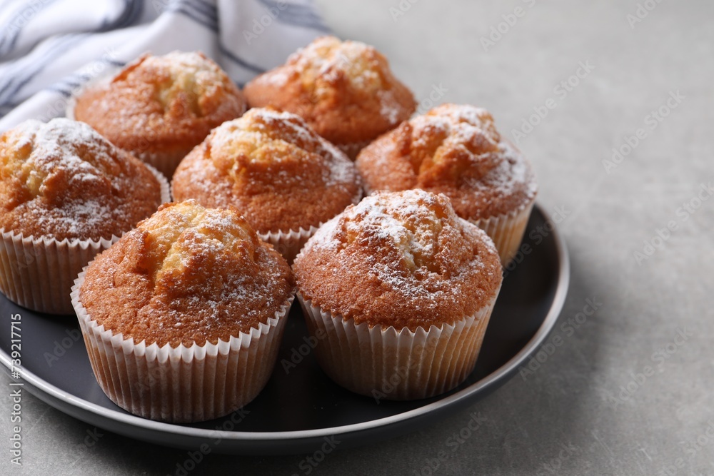 Delicious sweet muffins on light grey textured table, closeup. Space for text Delicious sweet muffins on light grey textured table, closeup. Space for text