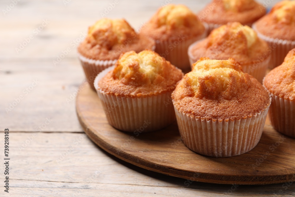 Delicious sweet muffins on wooden table, closeup. Space for text Delicious sweet muffins on wooden table, closeup. Space for text