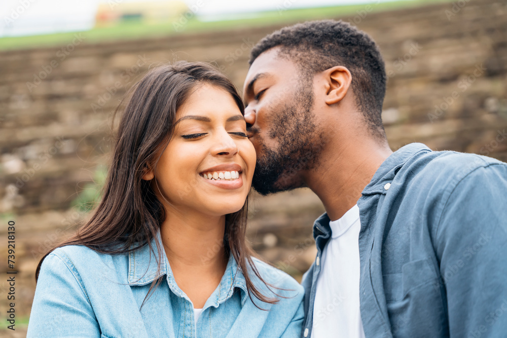 handsome man and beautiful woman hugging each other, walking, talking, having a date in the park handsome man and beautiful woman hugging each other, walking, talking, having a date in the park