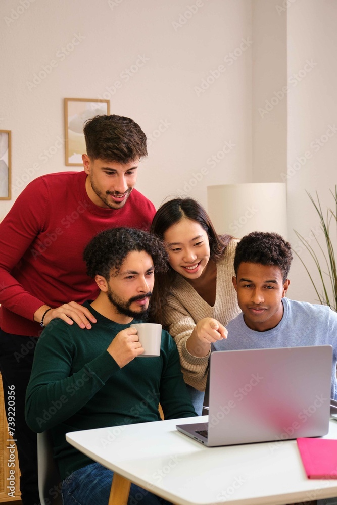 Group of diverse university colleagues studying together with a laptop at shared students house. Group of diverse university colleagues studying together with a laptop at shared students house.