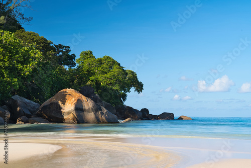 1 seconds long exposure of beautiful white sandy beach, granite rock boulders and turqouise water, Mahe, Seychelles 