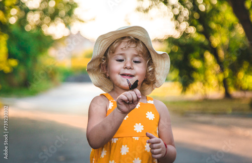 Photography A child catches a butterfly in nature. selective focus.