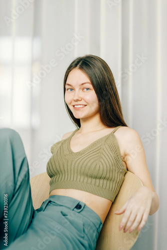 Close-up of a happy professional girl smiling at the camera. A light background and a place to copy.