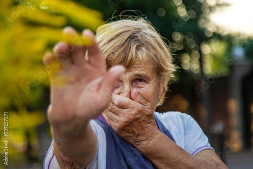 An elderly woman is allergic to ragweed. selective focus. photo