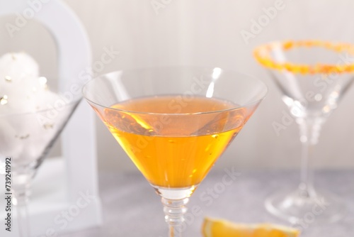 Tasty cocktails in glasses on gray table, closeup