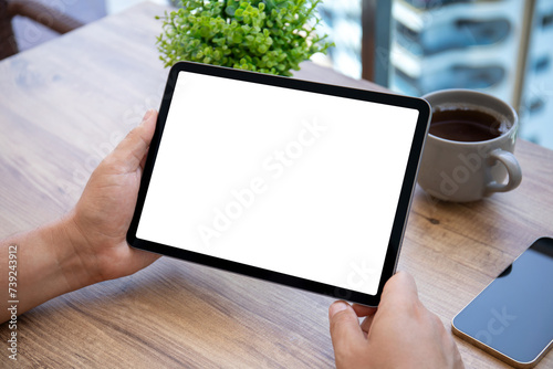 male hand hold computer tablet with isolated screen cafe office photo