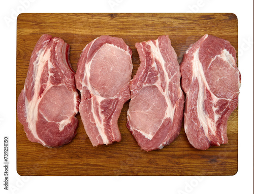 Pieces of fresh raw pork meat (pork steaks) on a wooden cutting board. Close-up. On a transparent background