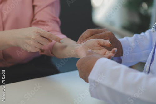 A young Asian female patient is being examined by a medical professional, A dignified middle-aged male doctor is diagnosing a patient's body in order to plan a treatment.