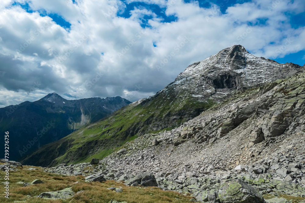 Panoramic view of majestic mountain peak Rameter Spitz in High Tauern National Park, Carinthia, Austria. Idyllic hiking trail over alpine terrain in summer. Escape in nature in remote Austrian Alps