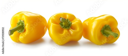 Vibrant three yellow peppers isolated on a white background for healthy cooking concept