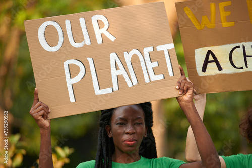 Environmental activist with handmade placard attending protest photo