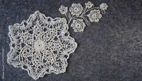 Beautiful white crochet openworks on dark marble table. Lace Vintage background Copy space.