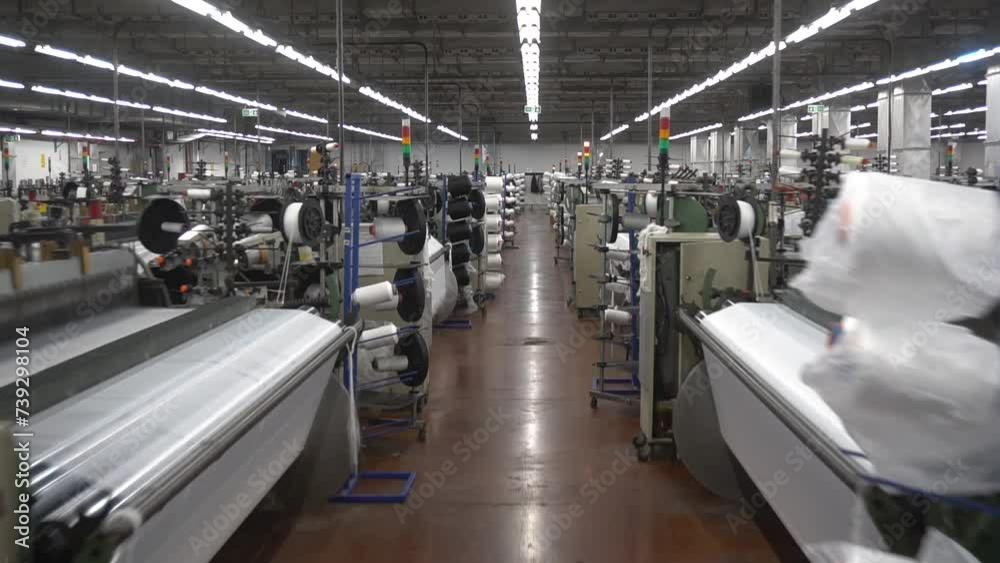 Weaving loom at a textile factory. Industrial fabric production line Weaving loom at a textile factory. Industrial fabric production line