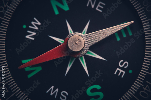 Dial compass in closeup, arrow indicates direction west.