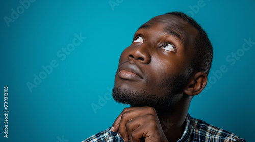 Curious and Wonder-filled West African Man, Isolated on Solid Background - Copy Space Included © DLC Studio