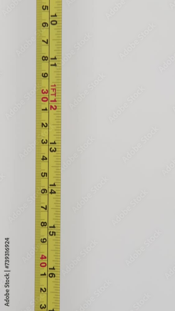 Use a tape measure to check the dimensions of the furniture. Details of the numbers on the ruler. Chroma key on a green background. Copy of the place. Use a tape measure to check the dimensions of the furniture. Details of the numbers on the ruler. Chroma key on a green background. Copy of the place.