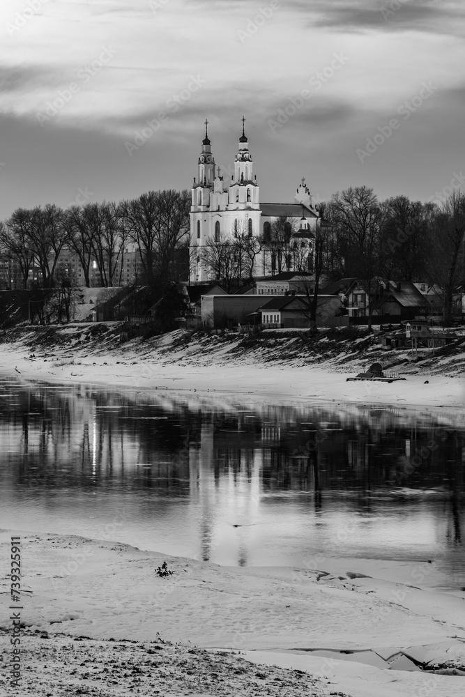 Fototapeta premium Black and white photograph of Polotsk St. Sophia Cathedral with reflection in the Western Dvina River at sunset
