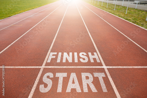 New beginnings concept. white starting line. word start and finish on a running track in a stadium. top view.