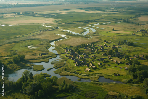 Aerial view, rural landscape, meandering rivers, verdant farmlands, bucolic village, pastoral beauty, agricultural fields, natural patterns, waterway network, country life, serene nature, green pastur