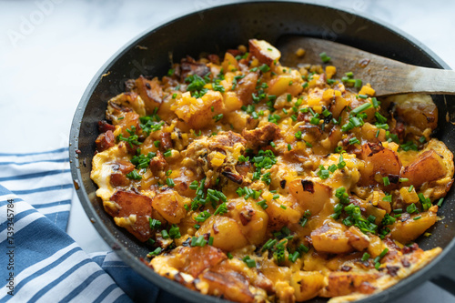 Fried potatoes with chorizo sausage, cheddar cheese and eggs