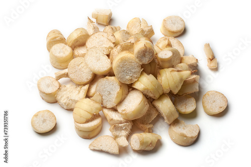pile of dried organic arrowroot rhizomes pieces to process into powder, maranta arundinacea, tropical plant known for starchy rhizomes harvested various culinary purposes, isolated on white background photo