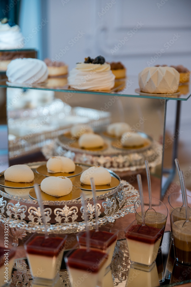 wedding mousse cakes on a candy bar on a gold stand