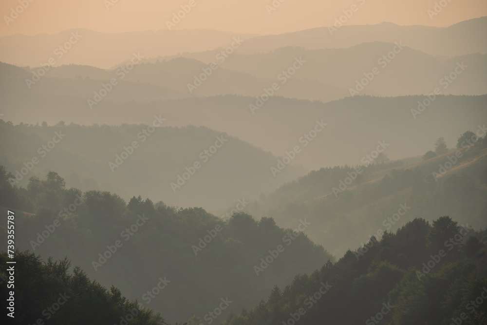 View of distant mountains and hills at sunset