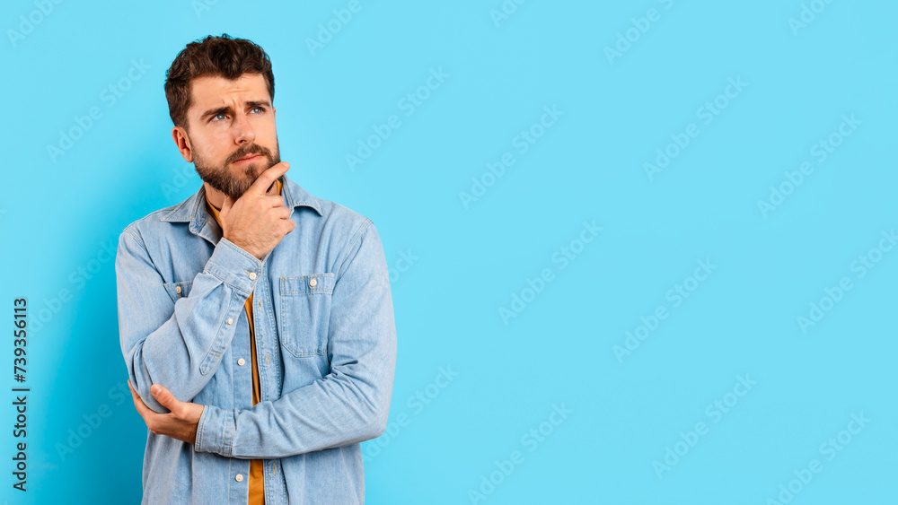 Portrait of thoughtful millennial man looking aside at copy space Portrait of thoughtful millennial man looking aside at copy space
