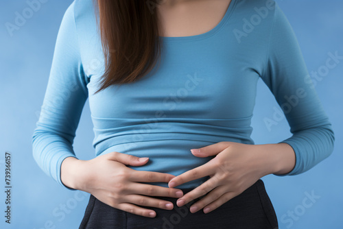 Close up of woman with menstrual cramps, stomachache or bloating photo