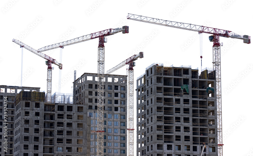 four cranes above grey unfinished block houses