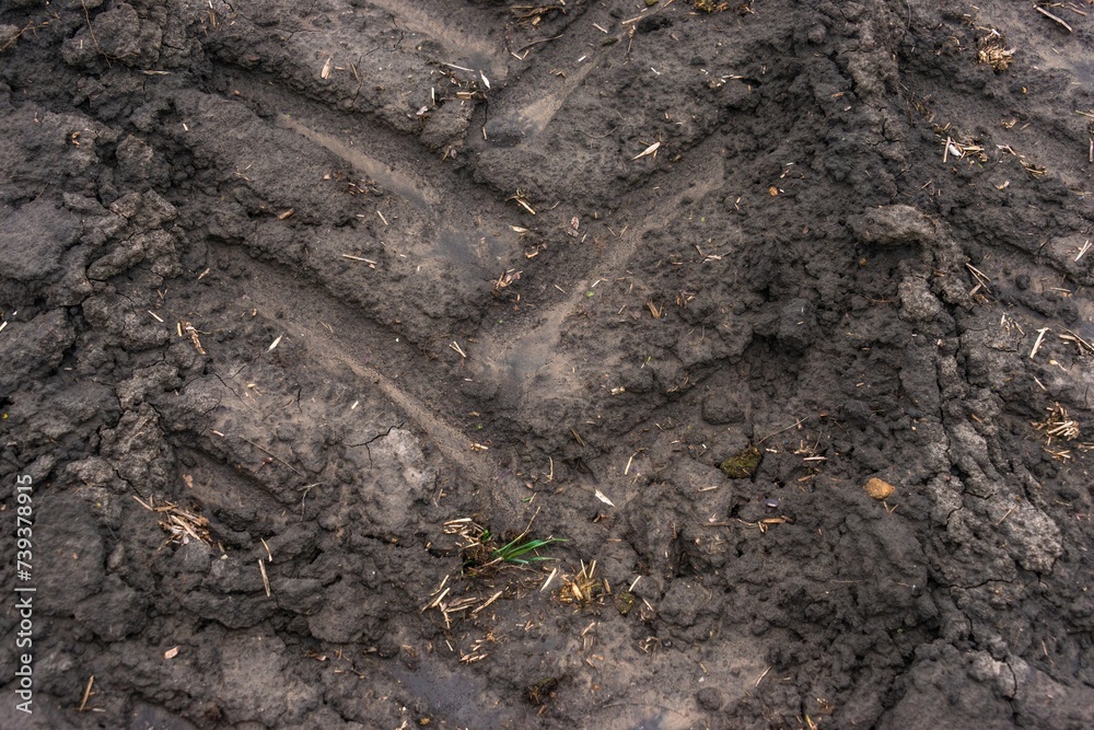tractor tread marks on dry soil (chernozem) due to drought on a sunny day in a snowless winter in southern Russia tractor tread marks on dry soil (chernozem) due to drought on a sunny day in a snowless winter in southern Russia