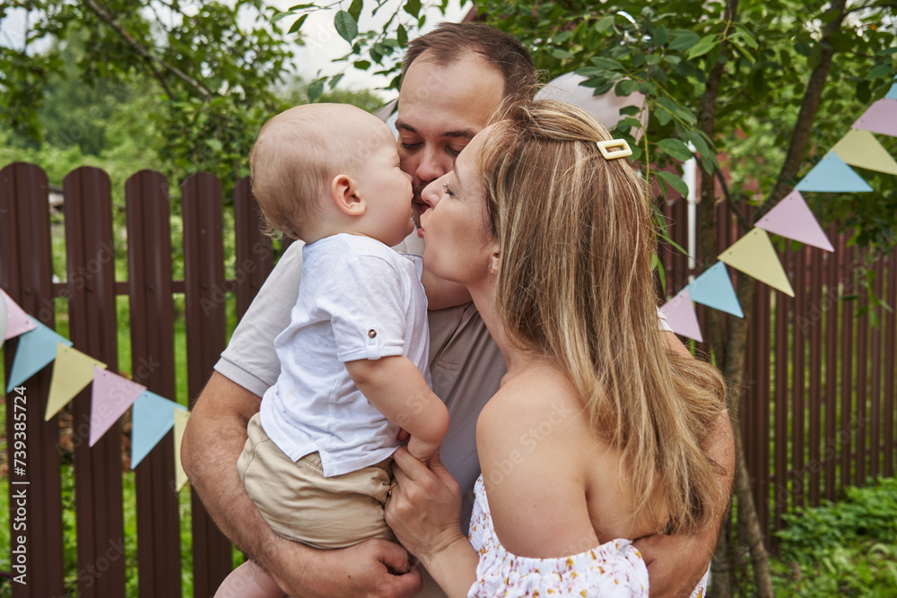 Fototapeta premium Joyful one-year-old boy's birthday celebration with his dear family members.