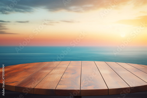 Empty wooden deck with serene sunset over ocean horizon background