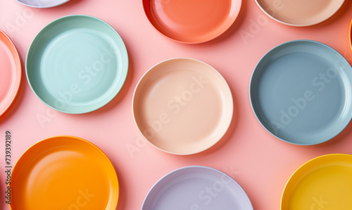 Minimal flat lay of slice Orange on colorful plates, Top view, pastel color plates