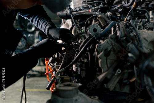 Картината върху платно close up On the service station table there is an elongated engine in which a ca