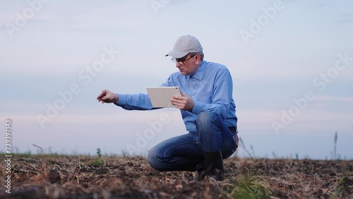 farmer looks soil field, farms, agronomist works unpaved soil, plowed soil field, farmer works hand digital tablet, tablet, corn cob, successful, farm worker, arms, human agricultural, sunlight photo