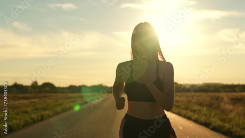 silhouette sports girl running along road sunset, summer thailand, healthy lifestyle, cardio wellness, athletics fitness, athlete exercise sunrise, woman running treadmill. healthy woman running photo