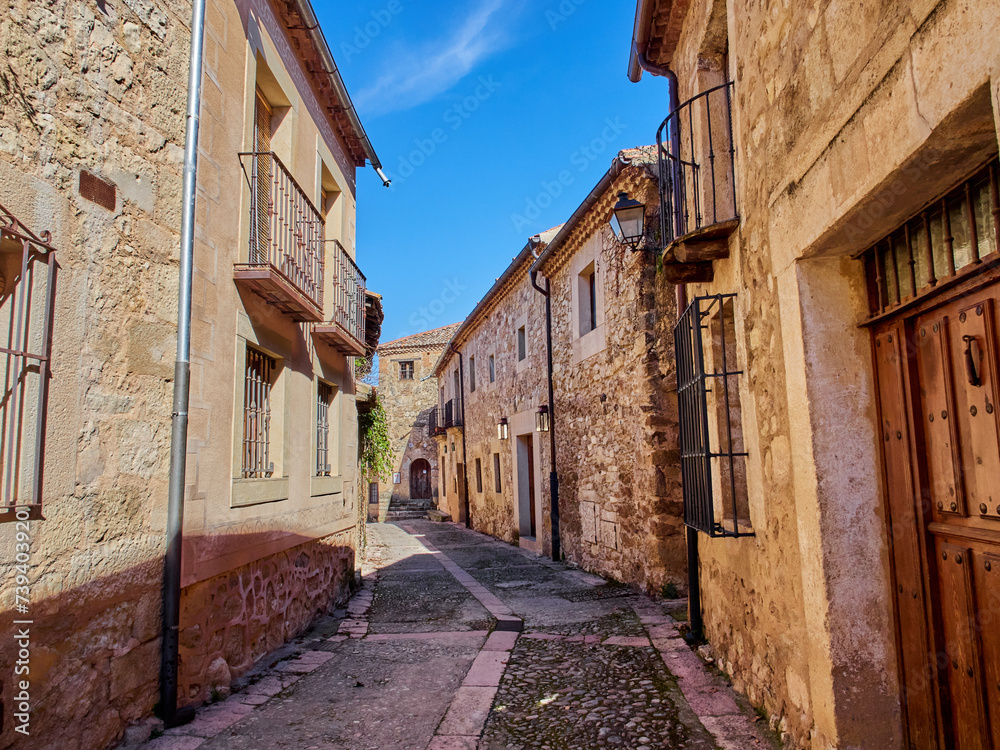 Cobblestone street with stone houses in Pedraza, a medieval walled village in the province of Segovia. Castilla y León, Spain, Europe