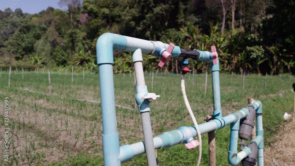 Irrigation pipes in a green field in Thailand Irrigation pipes in a green field in Thailand