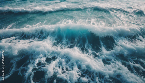aerial view of beautiful photo of blue water flowing in waves with white foam in a ocean. 