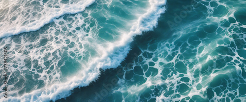 aerial view of beautiful photo of blue water flowing in waves with white foam in a ocean. 