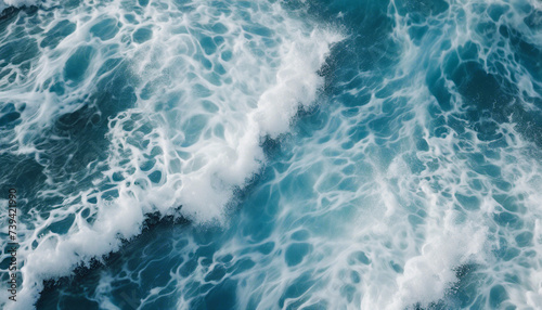 aerial view of beautiful photo of blue water flowing in waves with white foam in a ocean. 