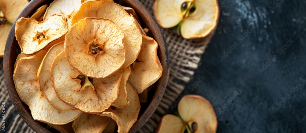 Freshly picked apples in a wooden bowl, some sliced in half for a healthy snack or baking ingredients