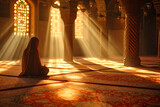 An Arab woman prays in a mosque illuminated by sunlight