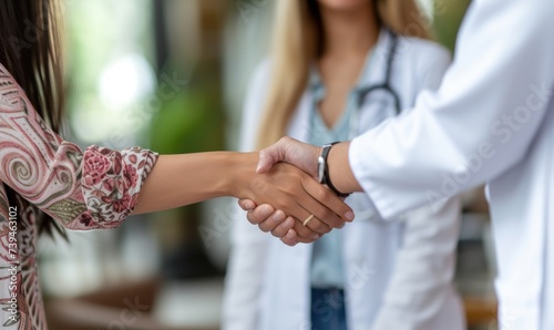 Doctor or medician shaking hands with patient.