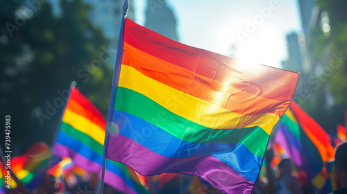 silhouette of a parade of gays and lesbians with a rainbow flag - symbol of love and tolerance photo